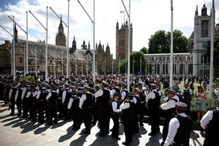 Members of the Metropolitan Police gather in Parliament Square ahead of a